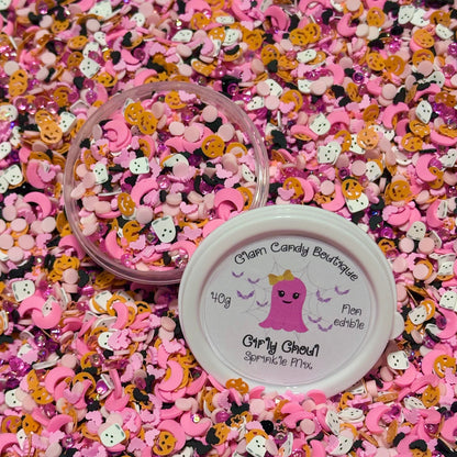 Pink and orange candy mix with a container labeled 'Charm Candy Boutique' on a pink background.