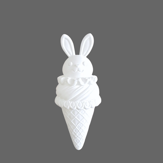 White plastic ice cream cone with bunny ears on a pink glittery background